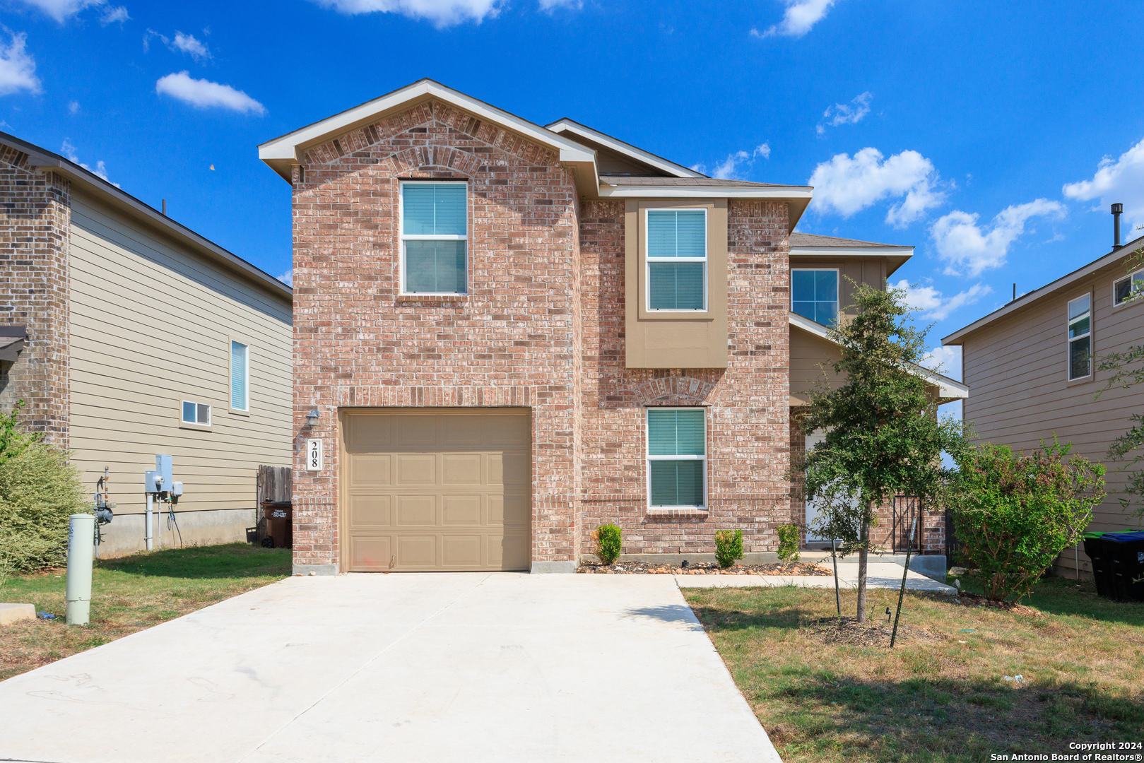 a front view of a house with a yard