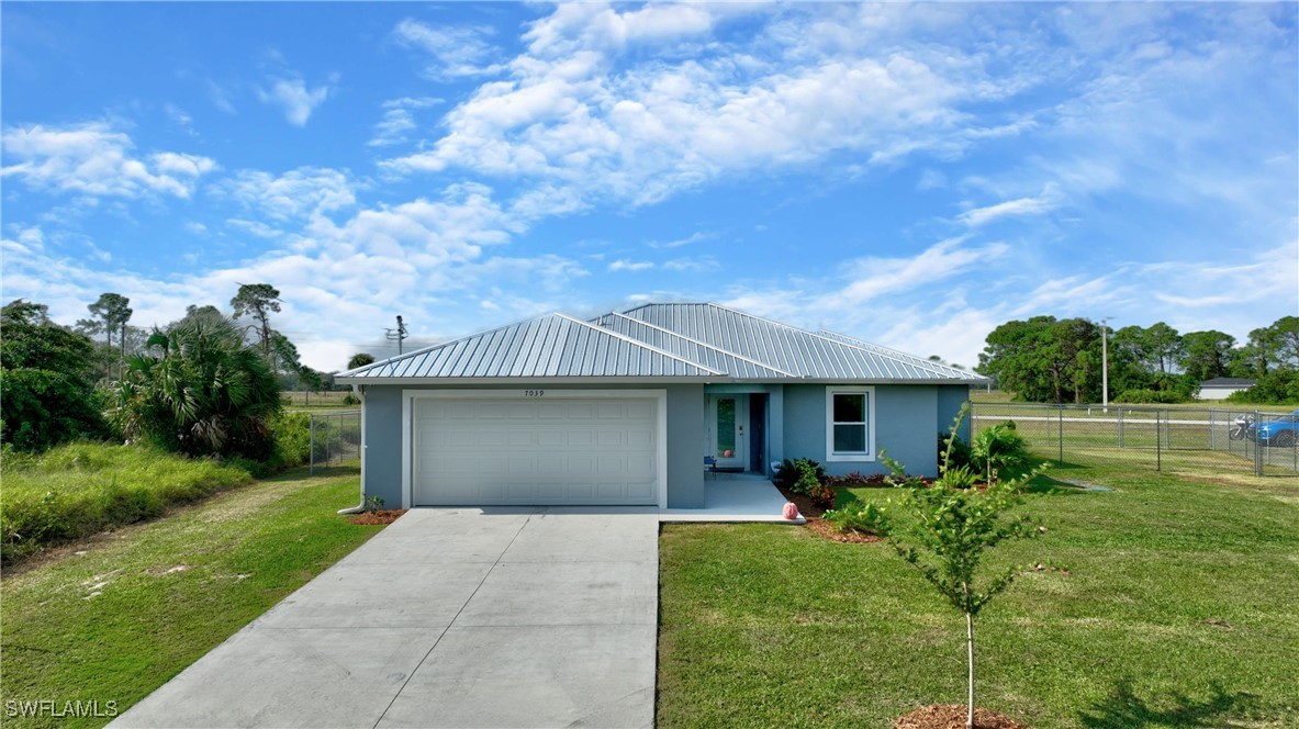 a front view of house with yard and green space