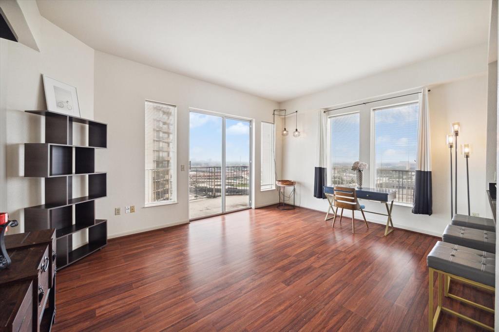 a view of a livingroom with furniture and a large window