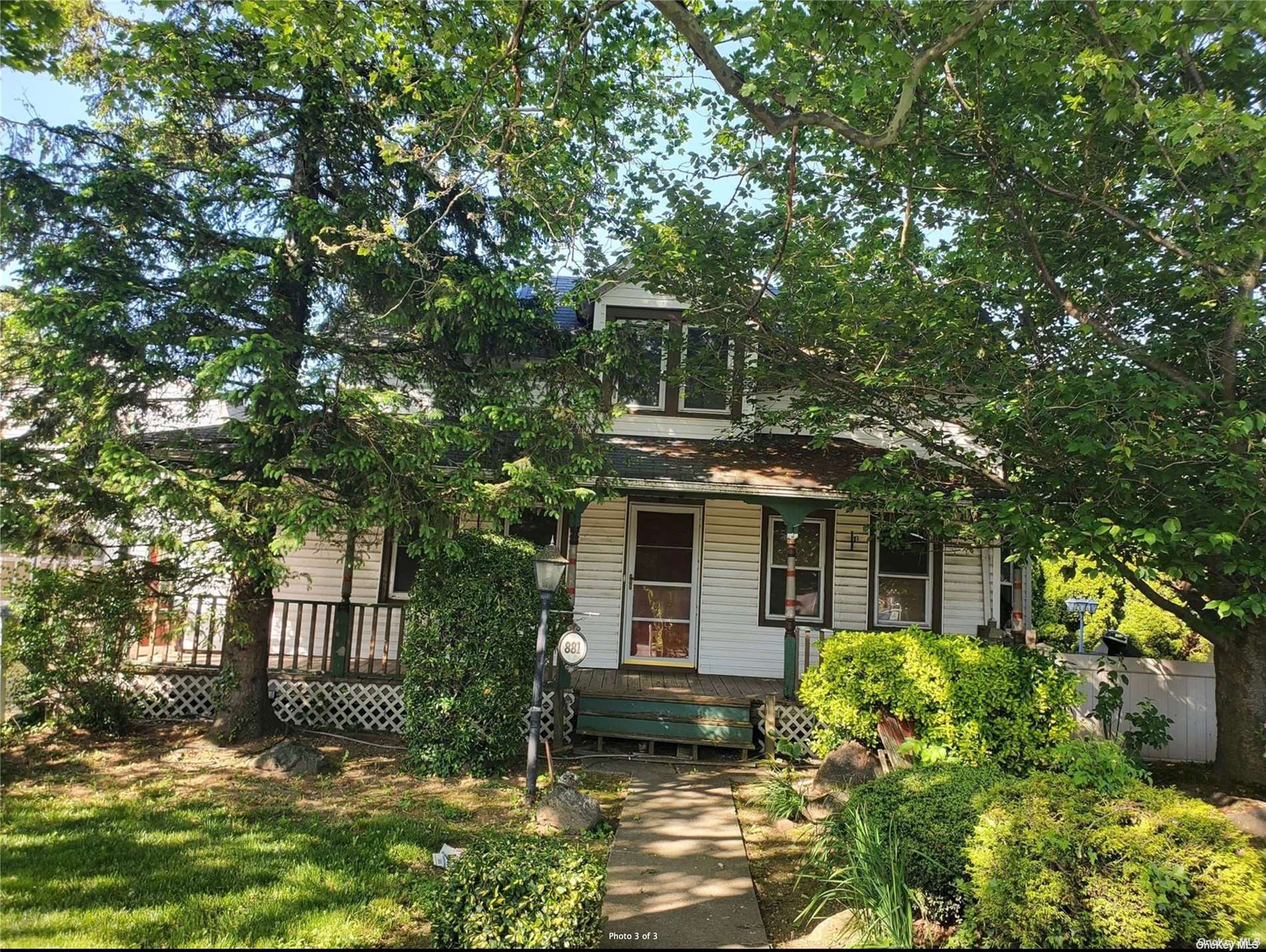 a front view of a house with a garden