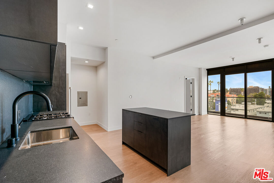 a kitchen with stainless steel appliances a stove a sink and a refrigerator