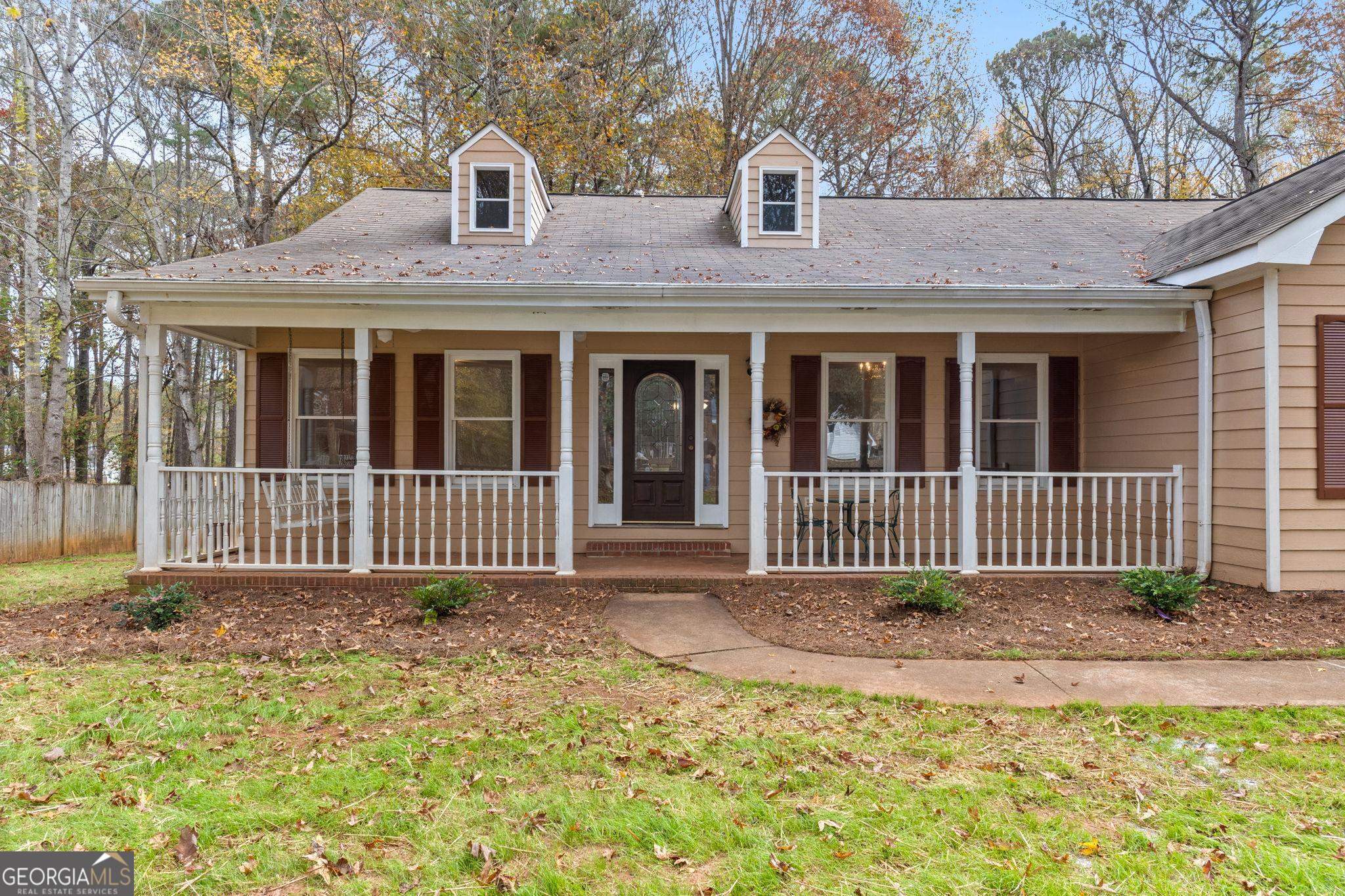 a front view of a house with a fence