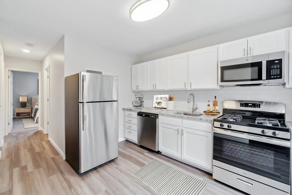 a kitchen with stainless steel appliances a refrigerator stove and microwave