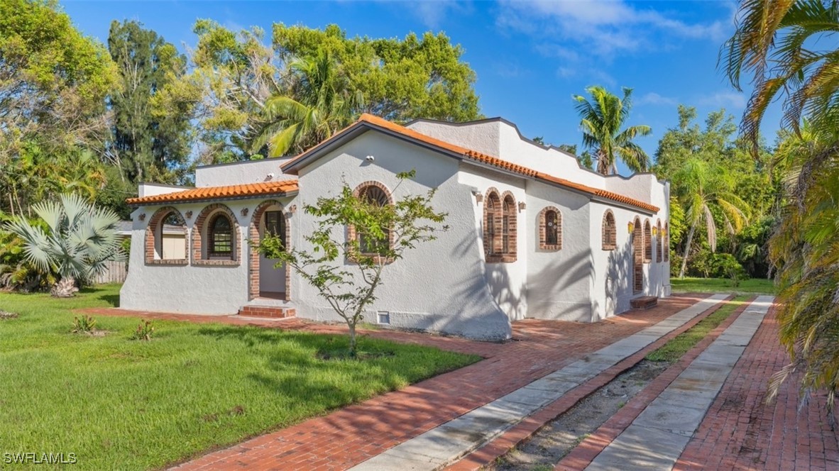 a front view of a house with garden