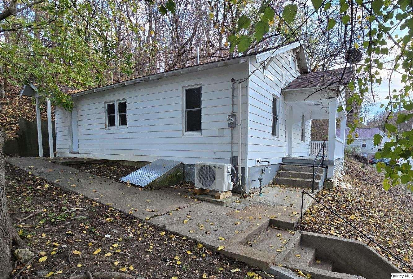 a view of a house with a yard and sitting area