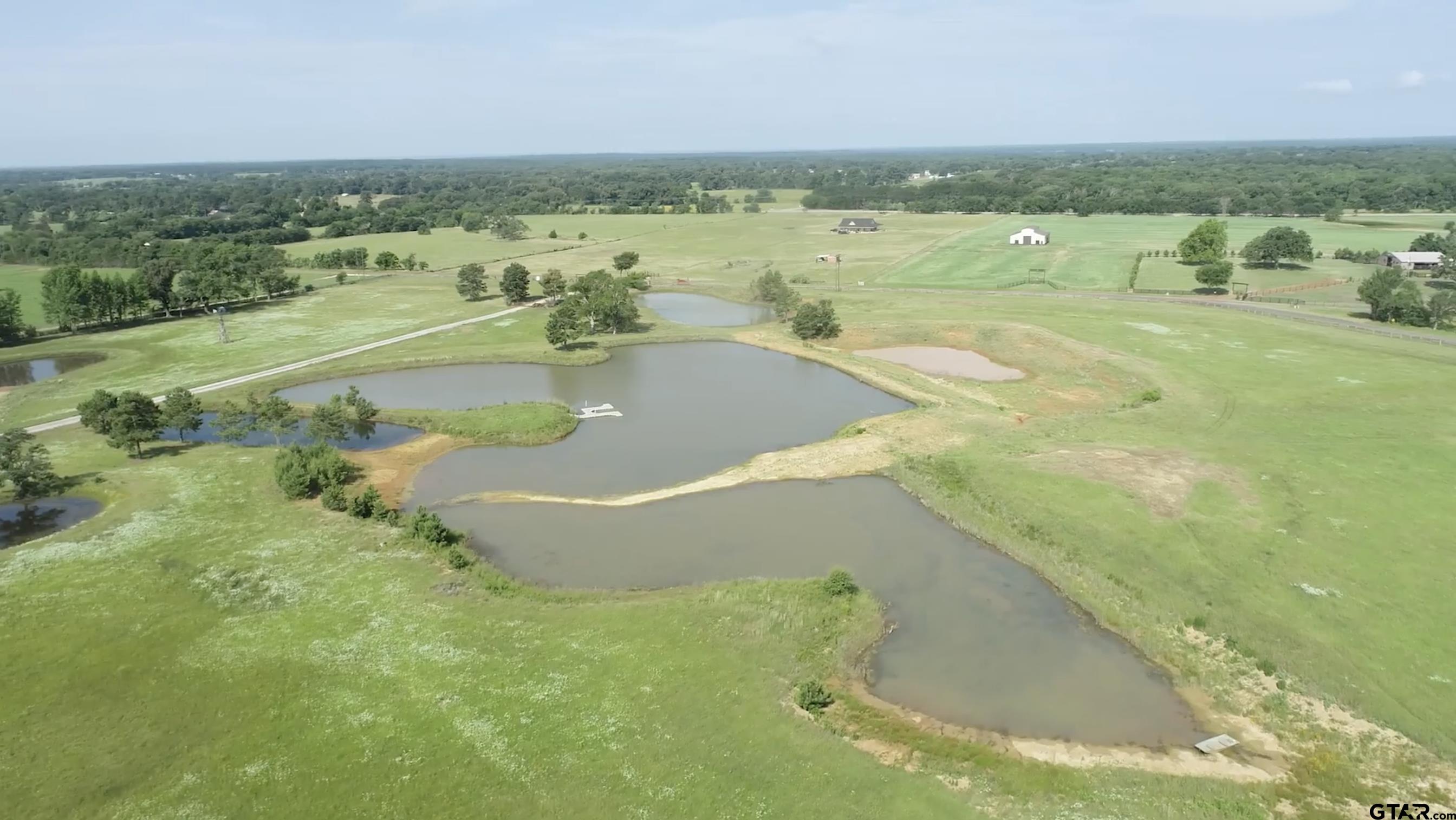 a view of a lake with a yard