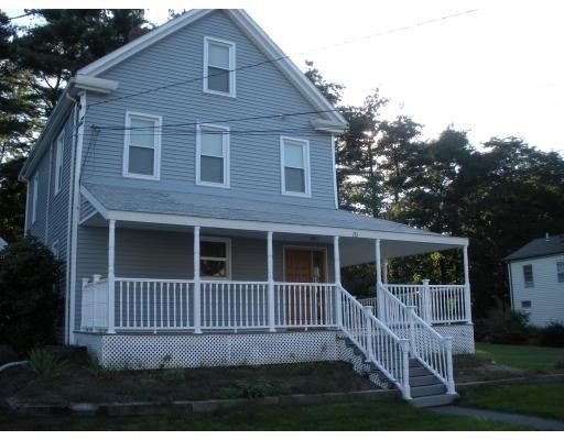 a view of a house with a window and wooden fence