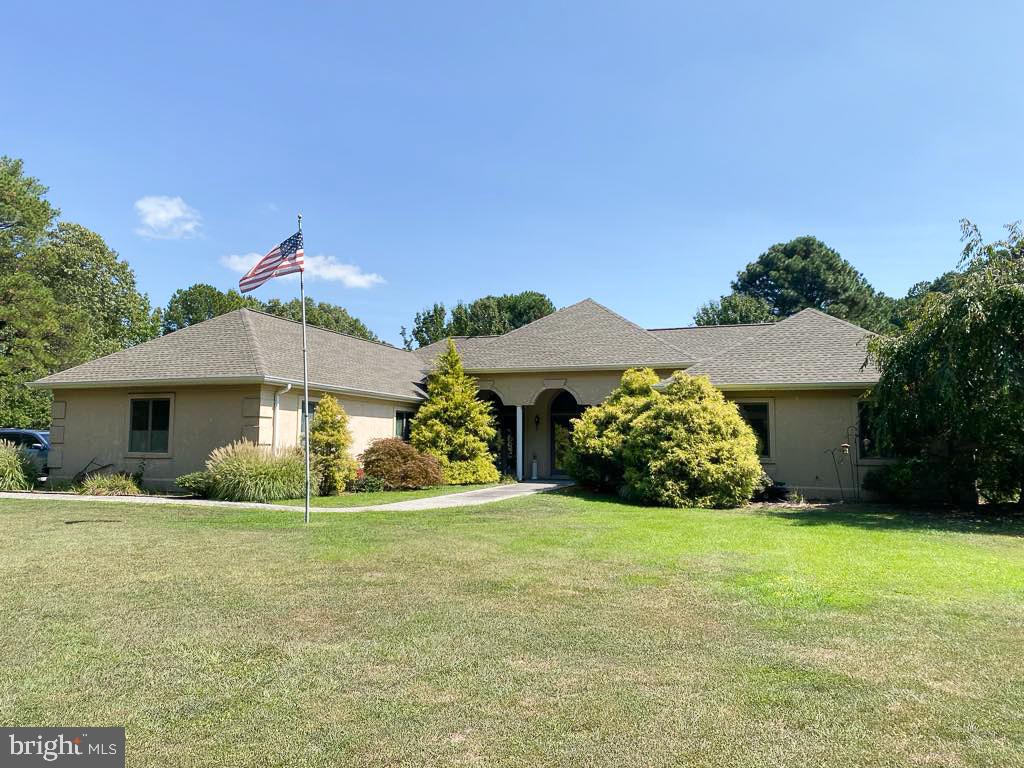 a view of house with yard and green space