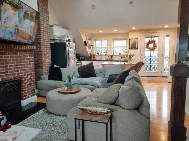 a living room with furniture and a fireplace