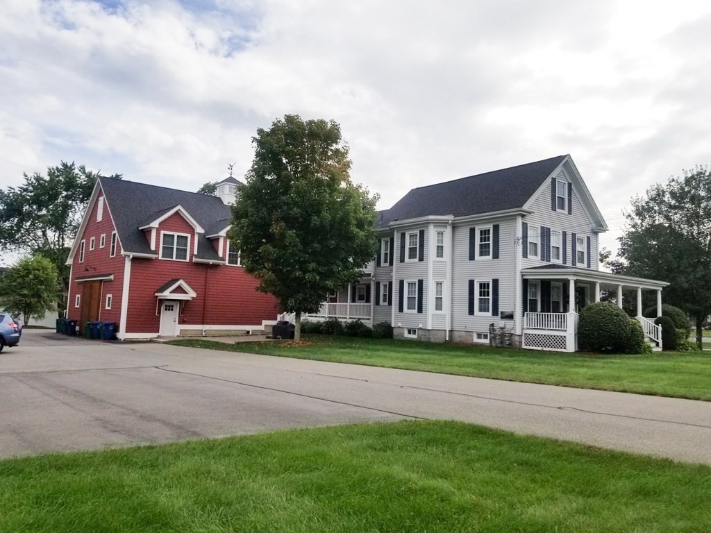 a front view of house with yard and green space