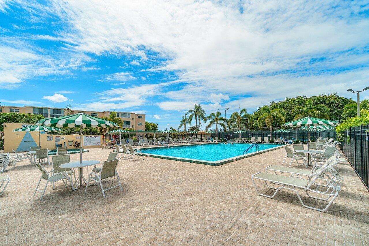 an outdoor space with swimming pool and furniture