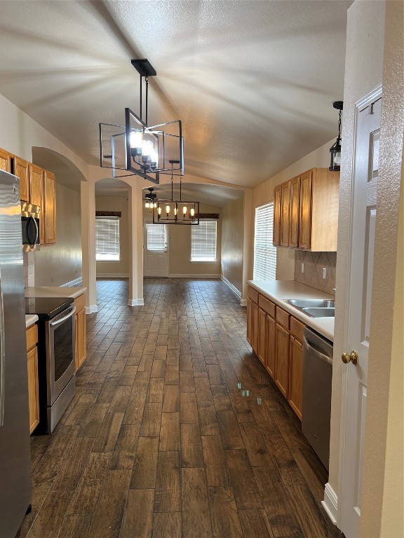 a view of a kitchen with a sink and wooden floor