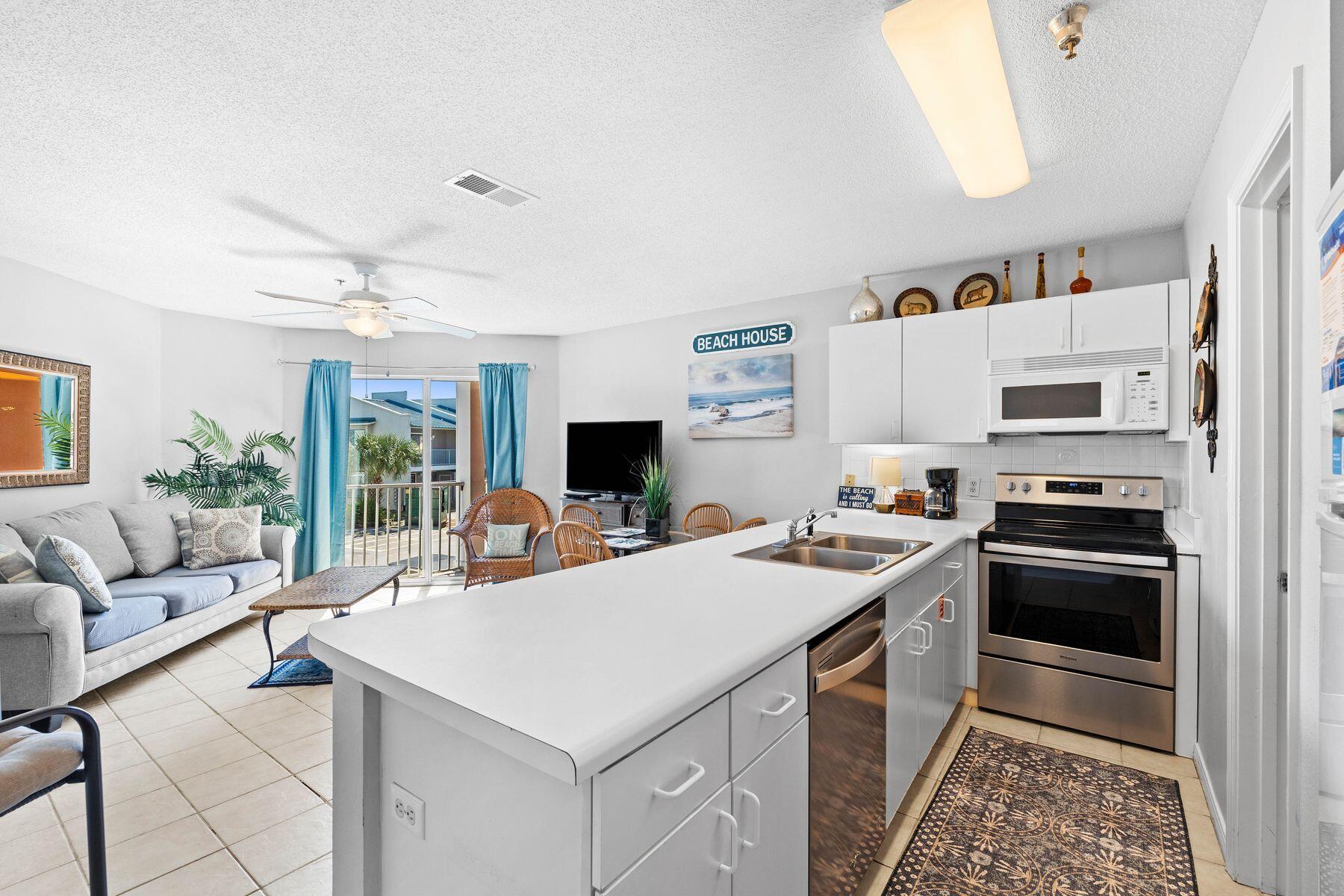 a view of kitchen with sink stove and refrigerator