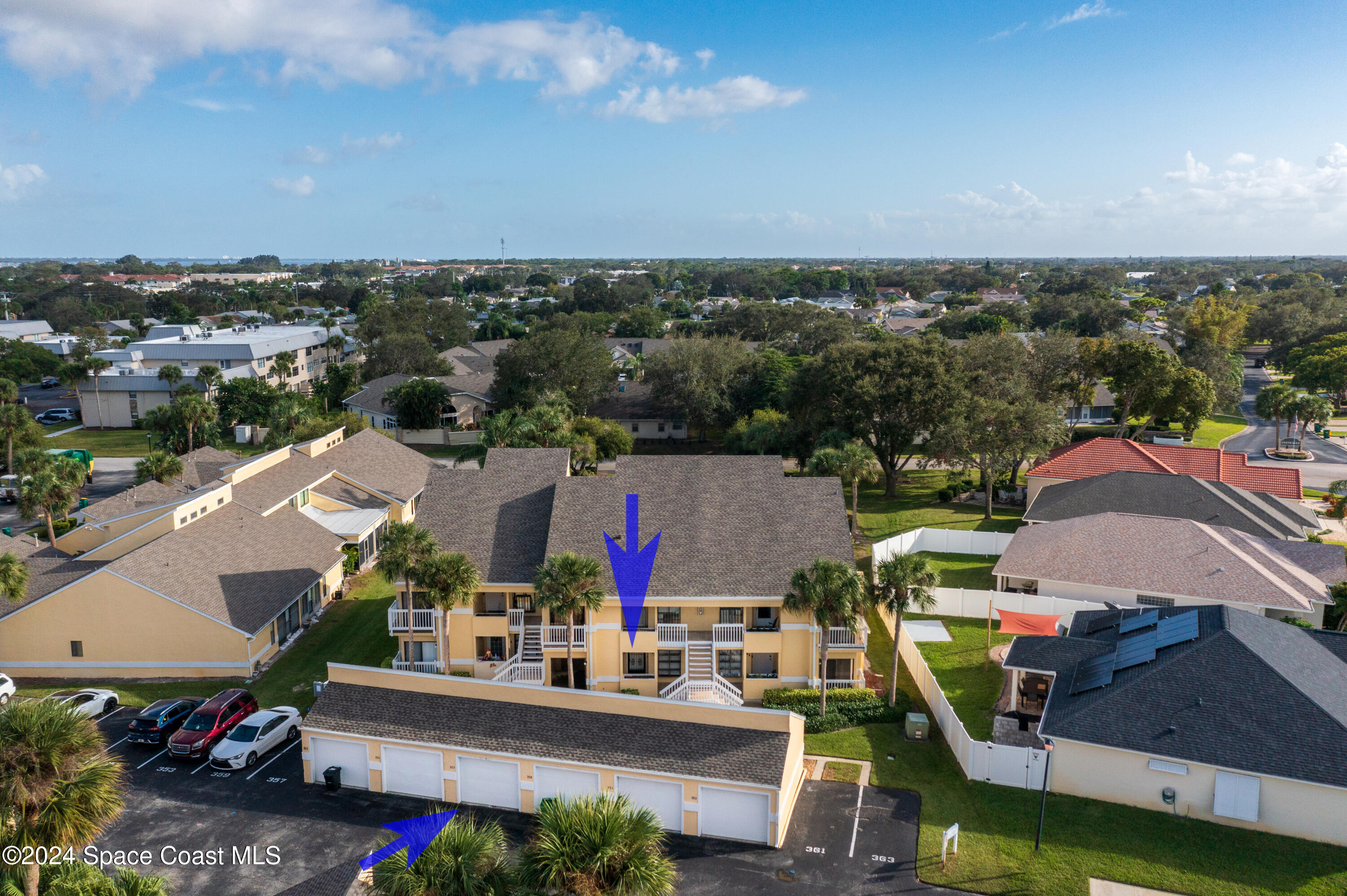 an aerial view of a houses with a swimming pool