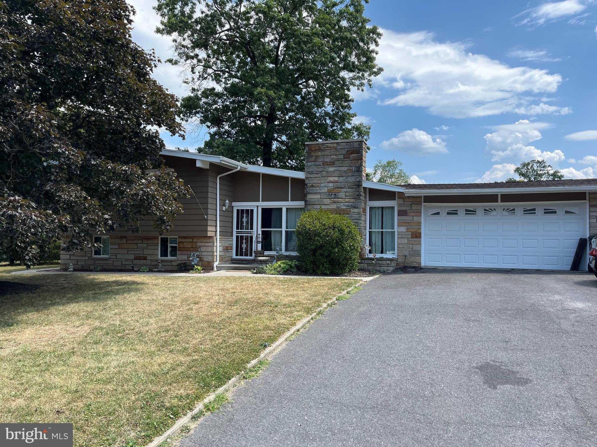 front view of a house with a trees