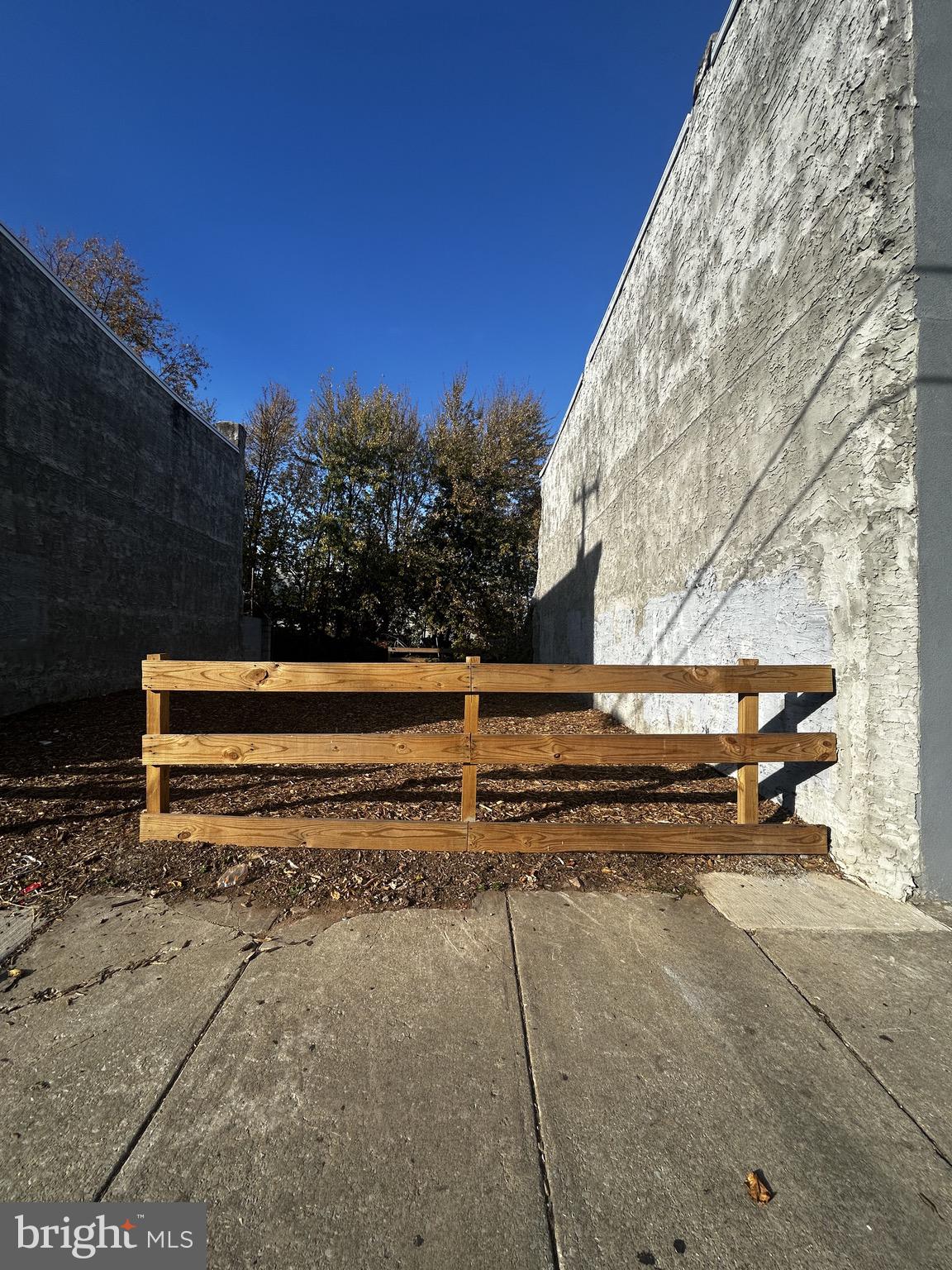 a view of backyard with wooden fence