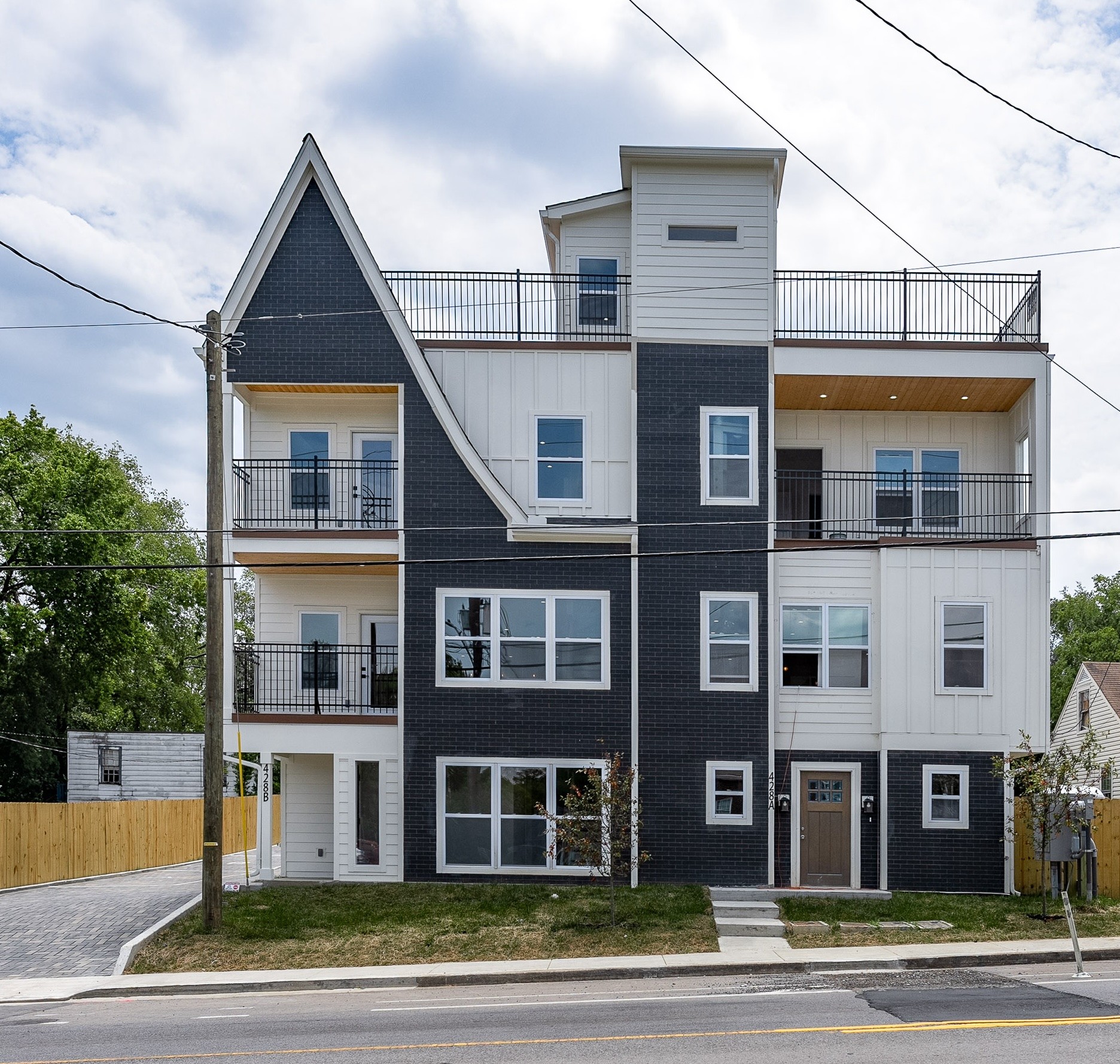 a front view of a residential apartment building with a yard