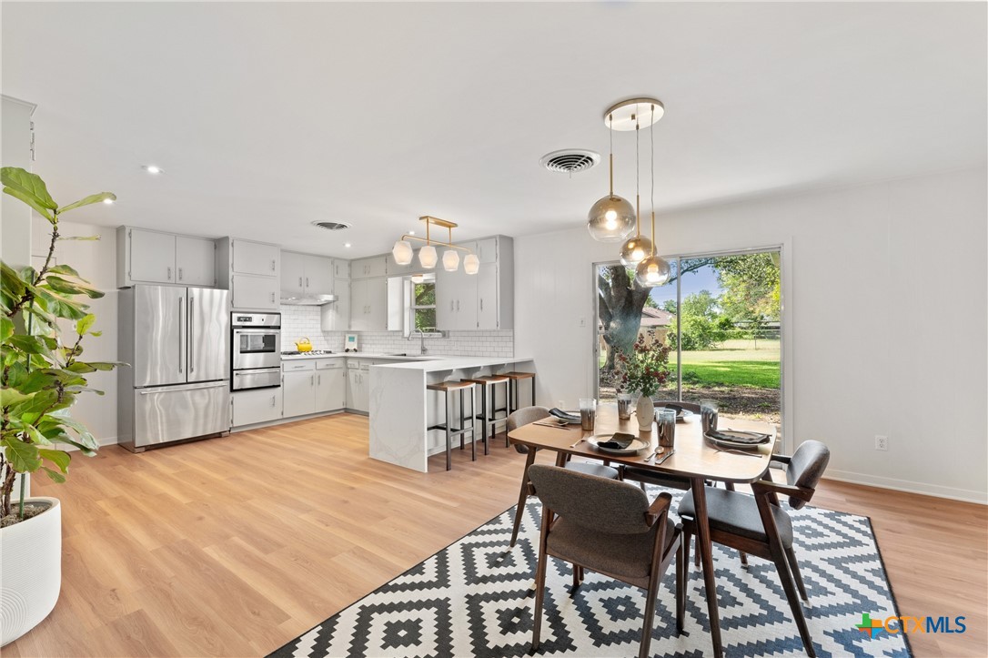 a dining room with furniture a chandelier and a rug