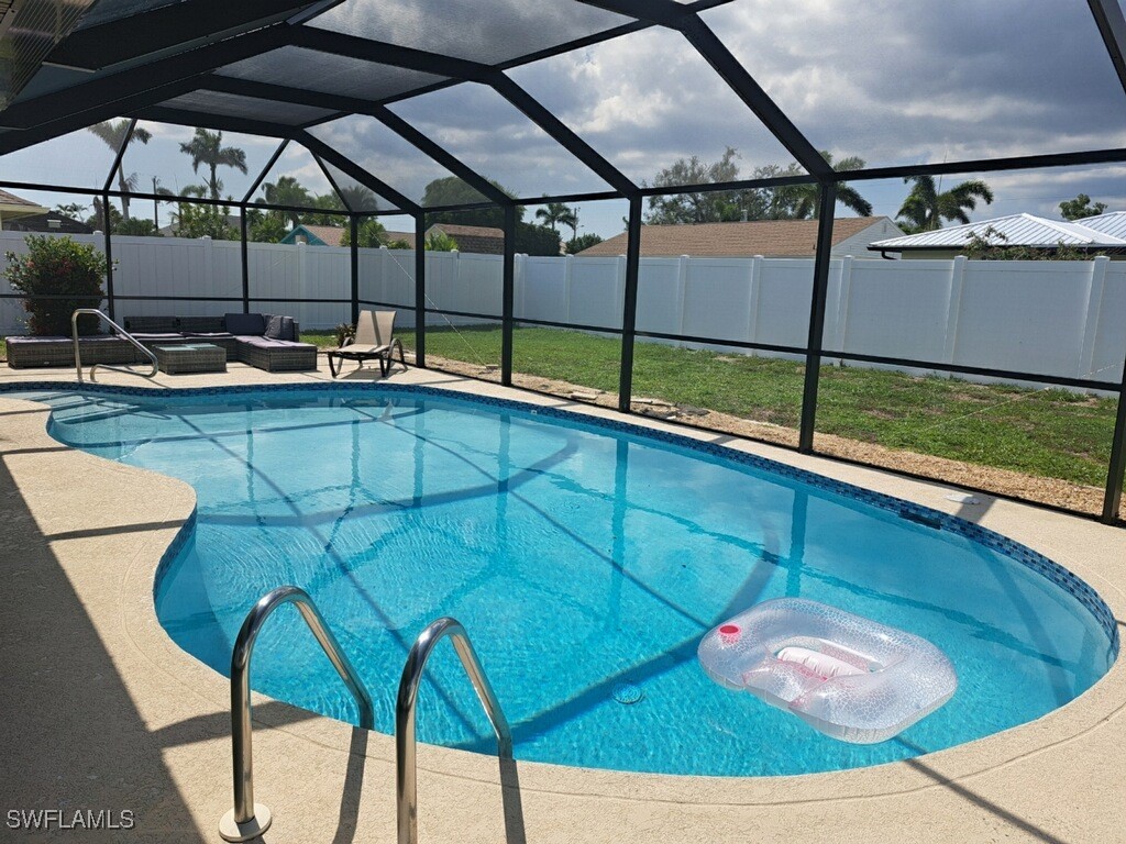 a view of a backyard with table and chairs under an umbrella