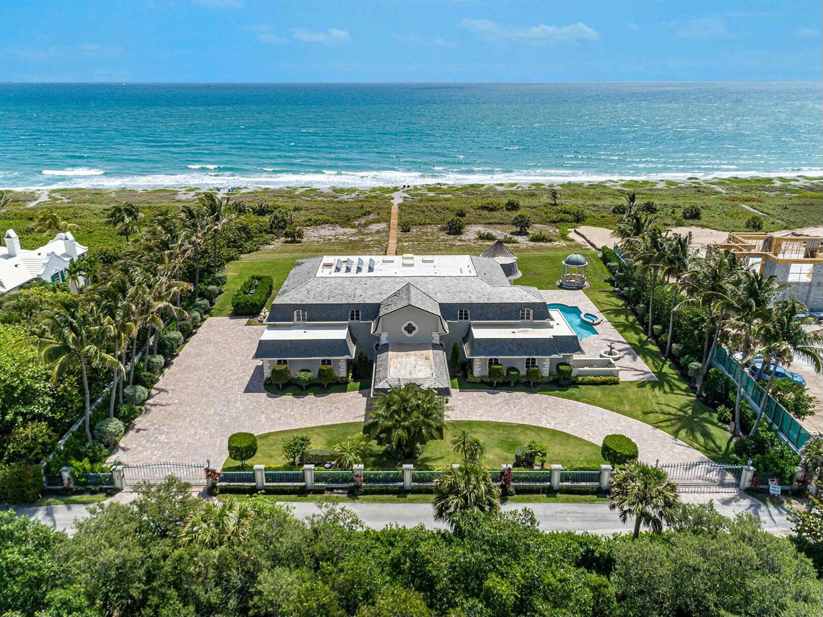 an aerial view of a house with a ocean view