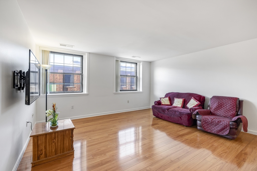 a living room with furniture window and wooden floor