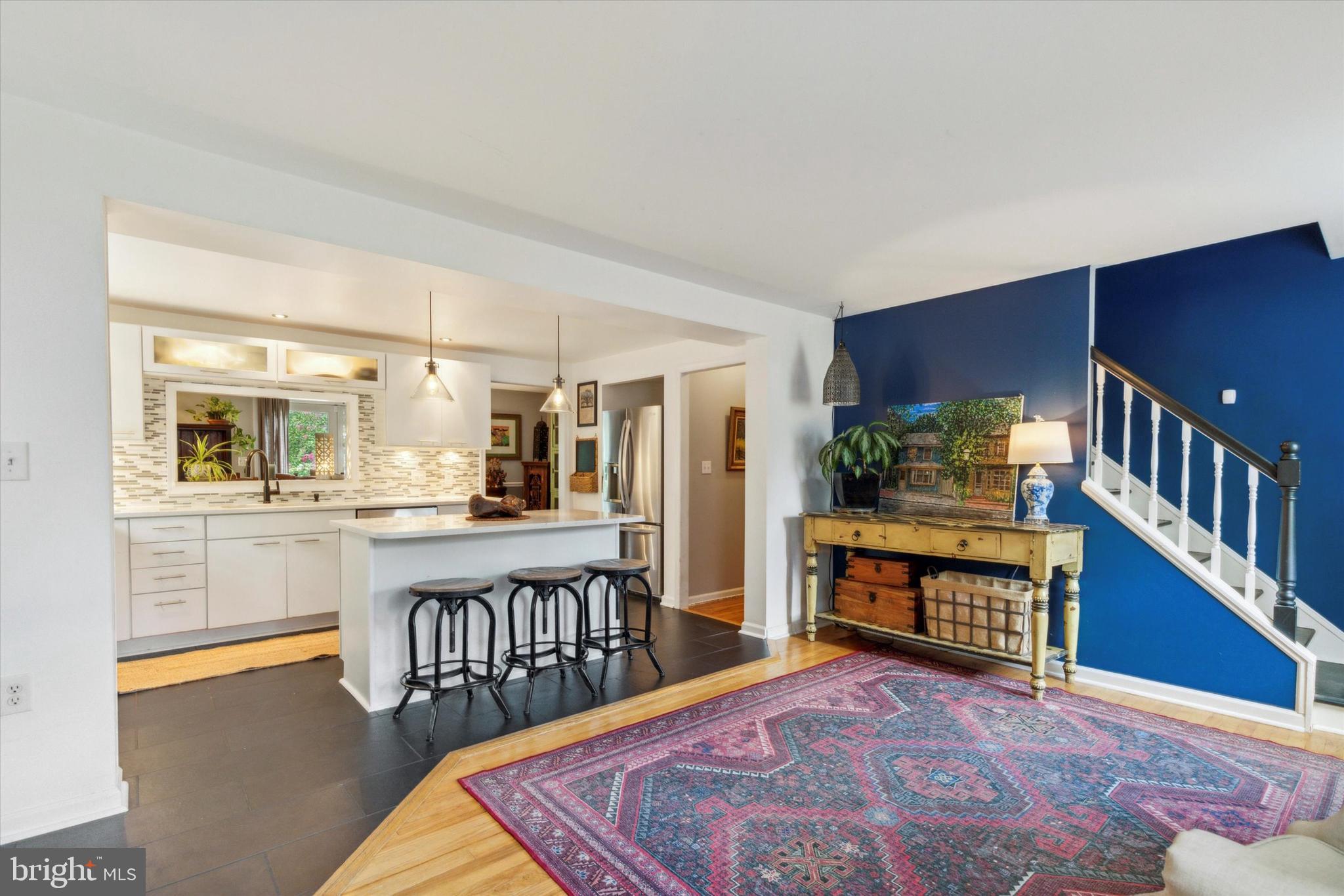 a living room with furniture a rug and a wooden floor