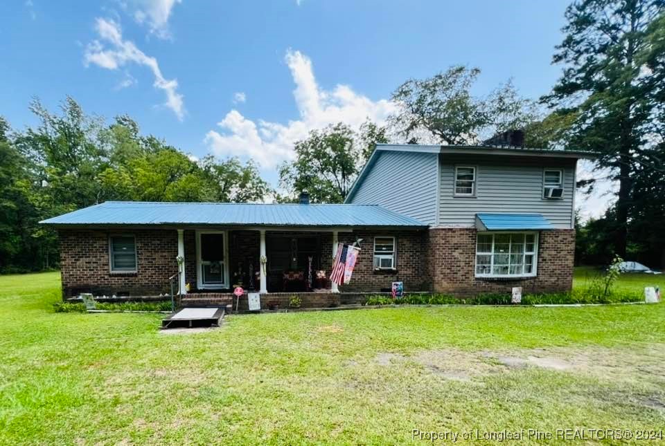 a view of a house with backyard and porch