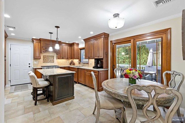 a kitchen with a table chairs refrigerator and microwave