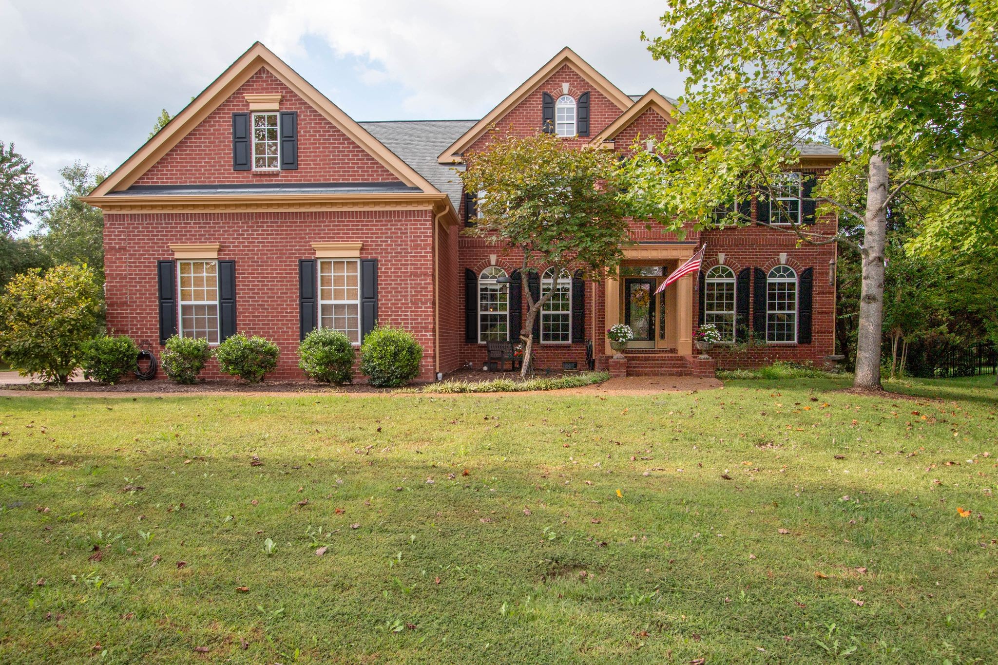 a front view of a house with garden