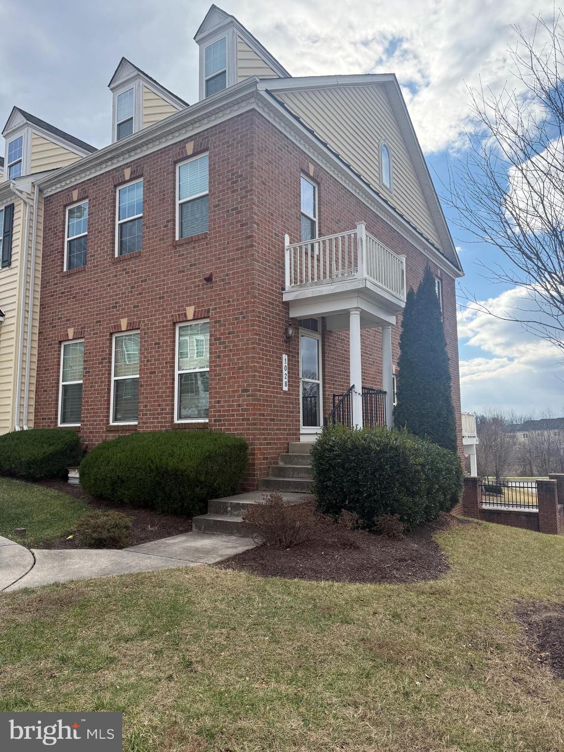 a view of a brick house with a yard