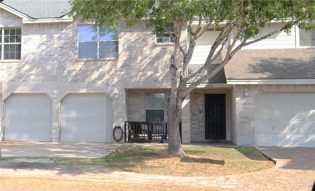 a view of a house with a yard and garage