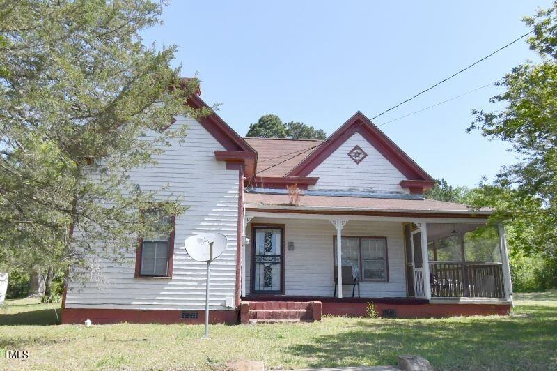 a view of a house with yard and tree s