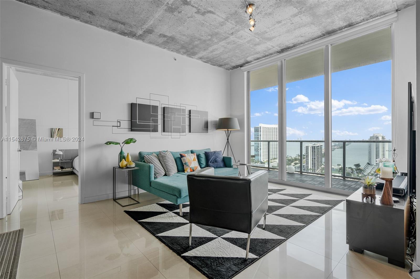 a living room with furniture and a floor to ceiling window