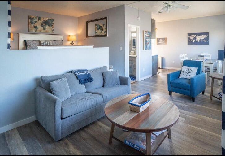 a living room with furniture and a wooden floor