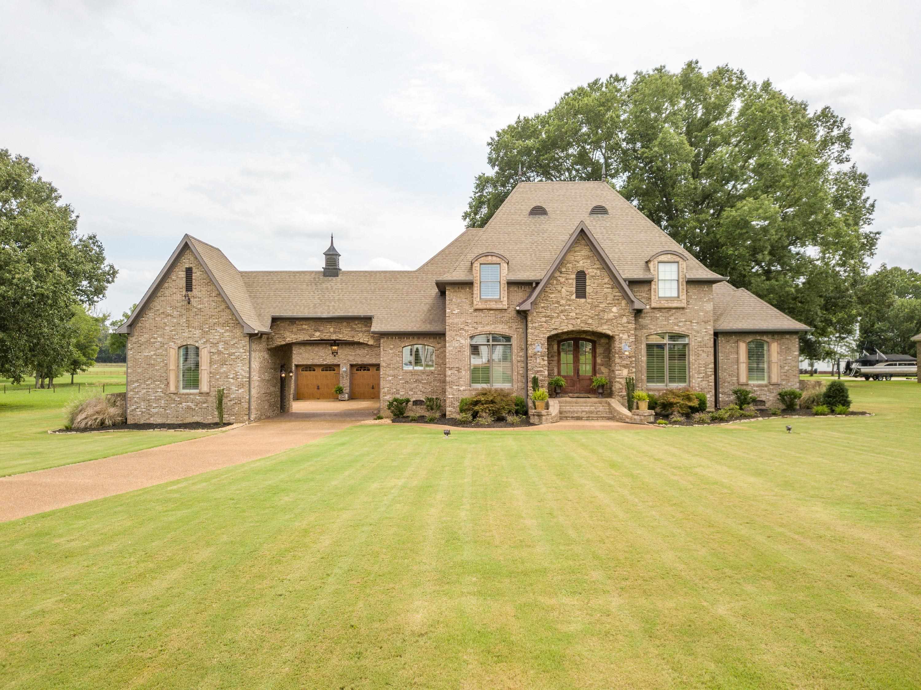 a front view of a house with yard and garage