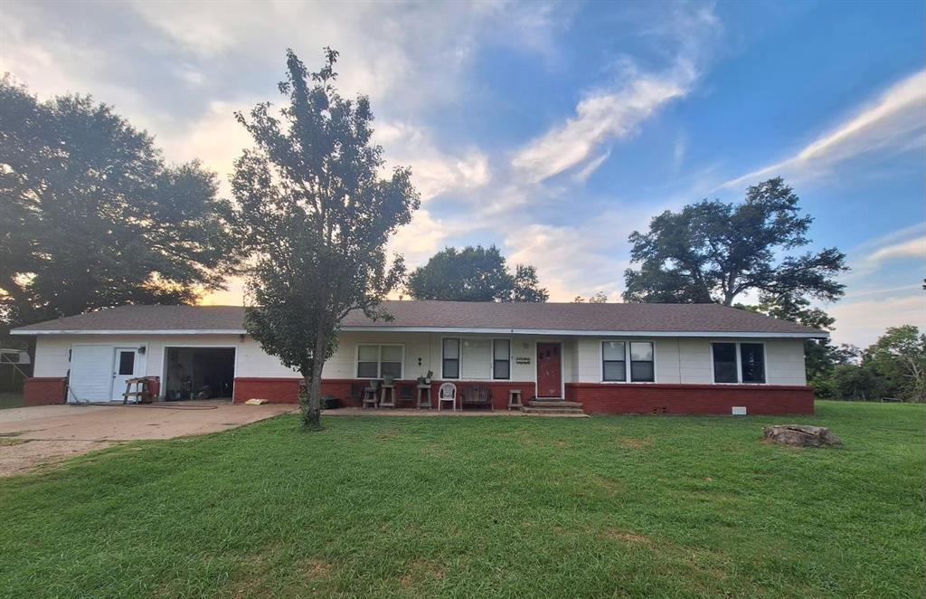 a view of house that has a yard