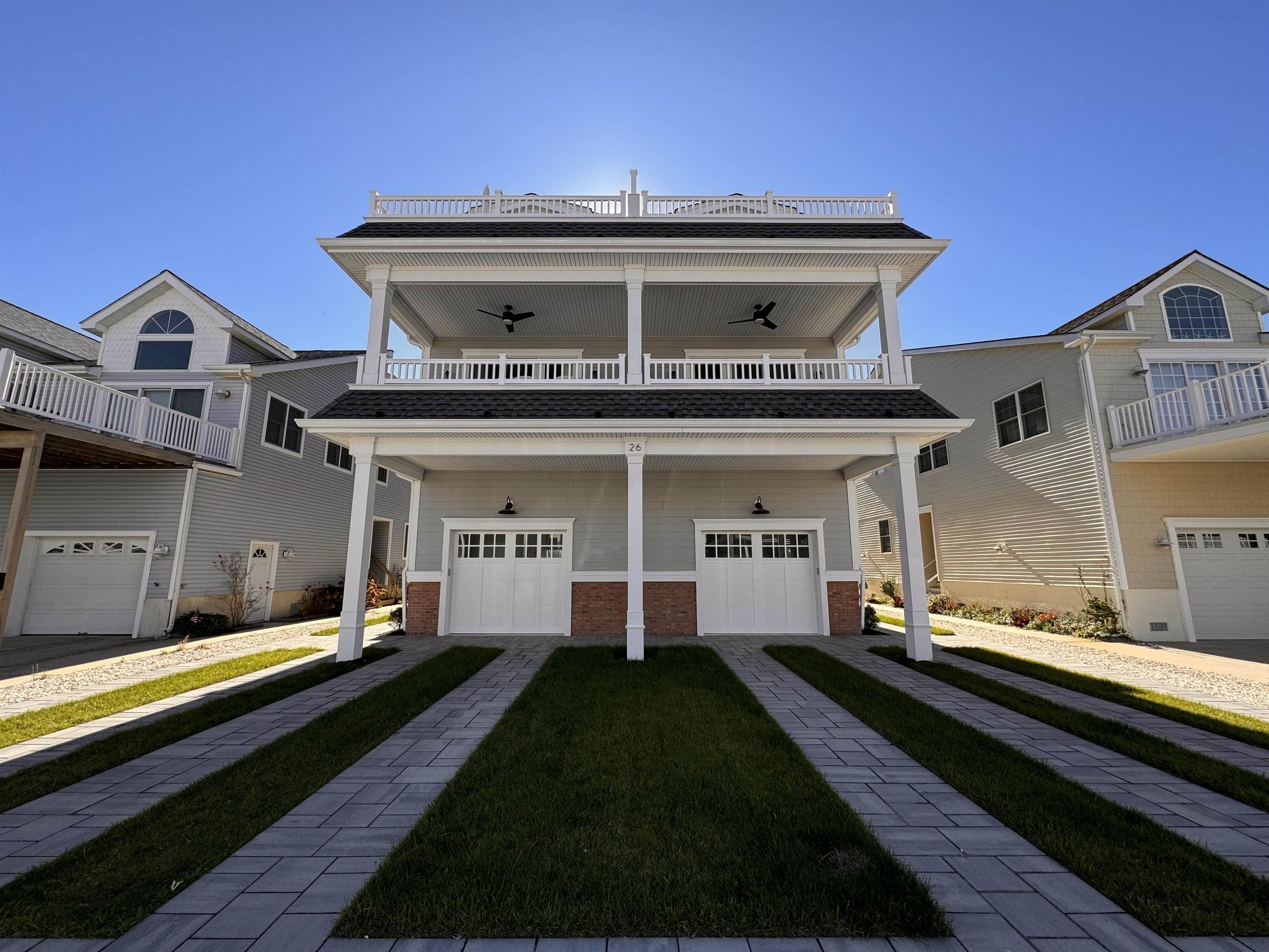 a front view of a house with a garden and plants