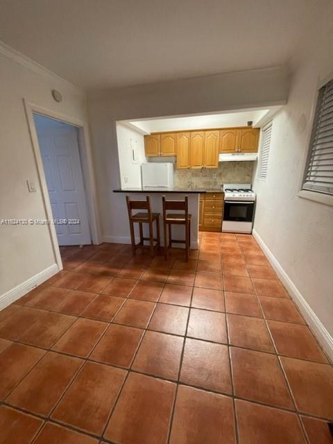 a view of a kitchen with furniture and window