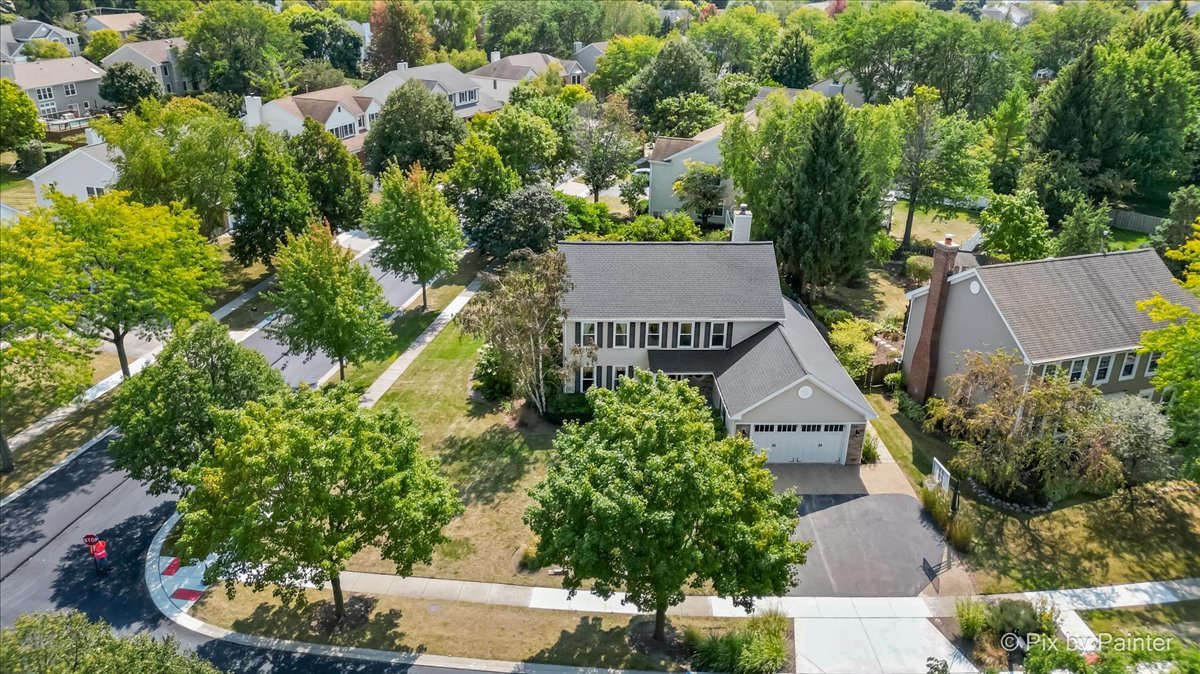 an aerial view of a house with a yard