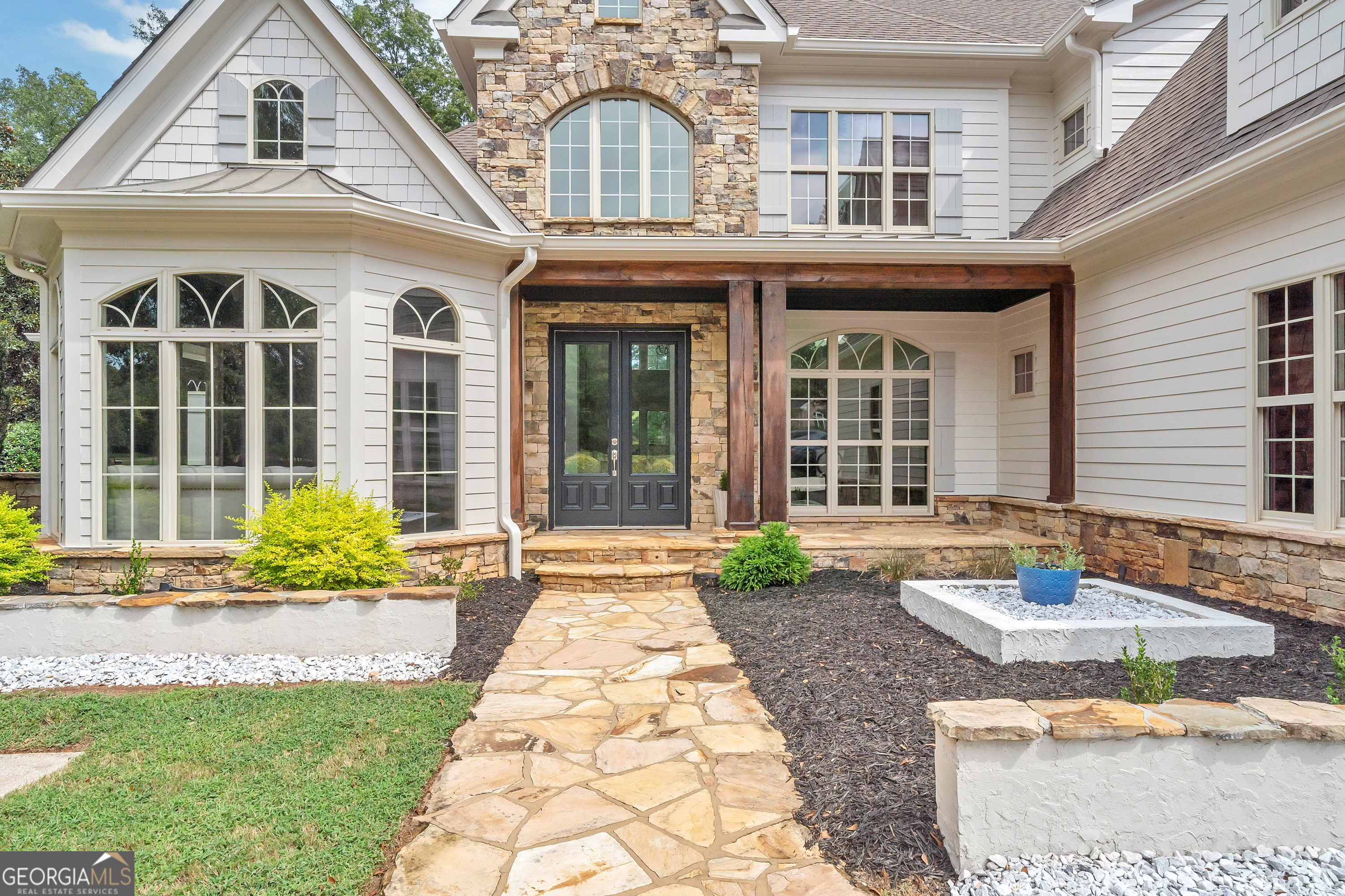 a front view of a house with sitting area and garden