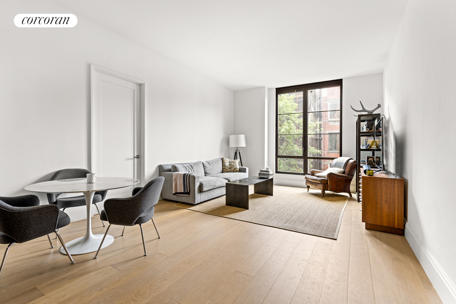 a living room with furniture and large windows