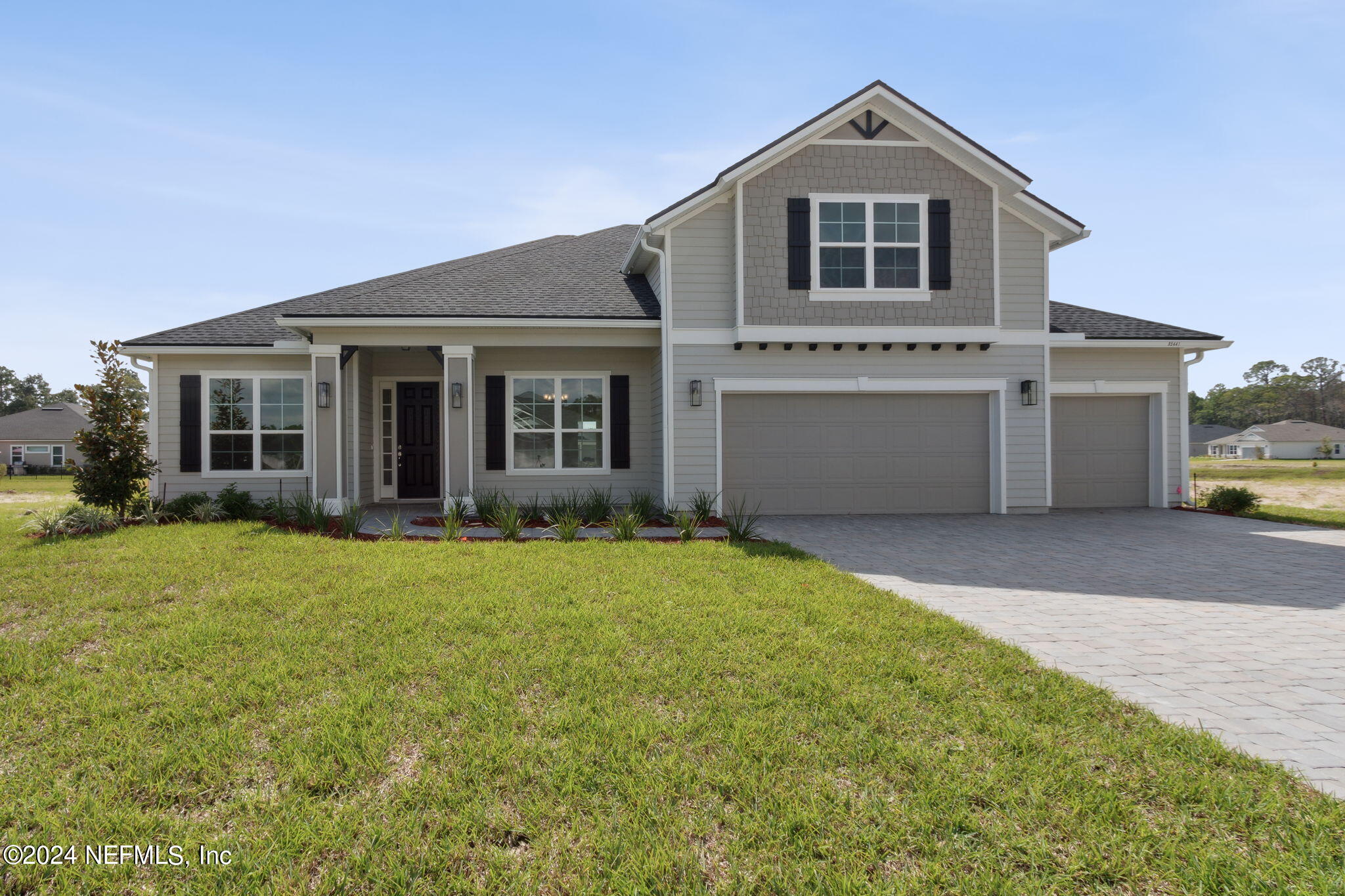 a front view of a house with a yard and garage