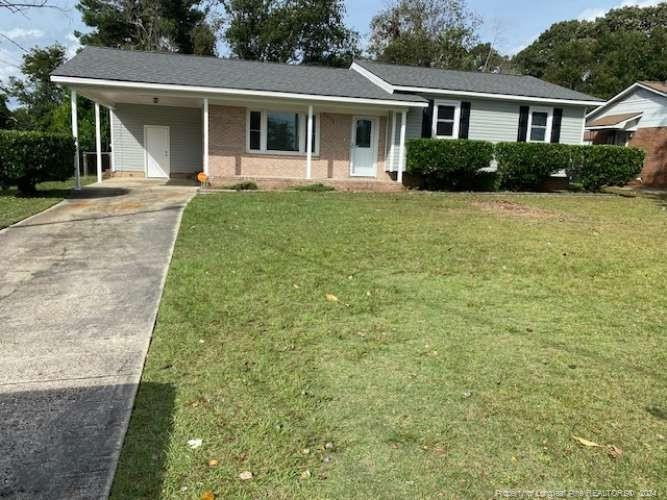 a front view of a house with a yard and porch