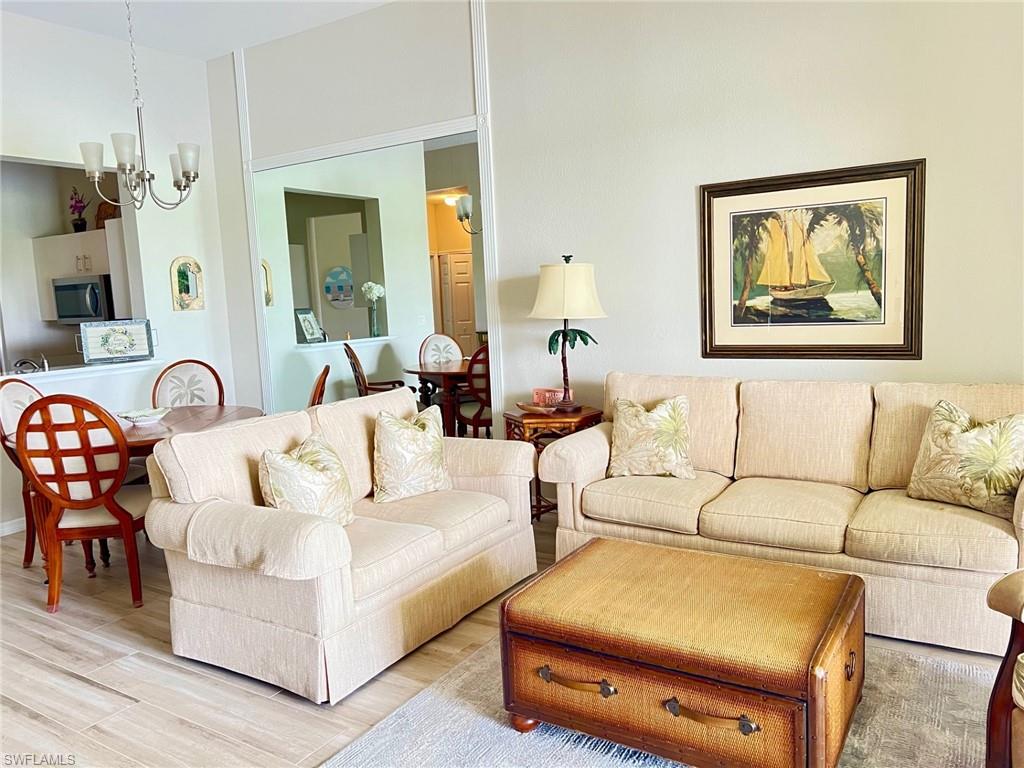 a living room with furniture a table and painting on the wall