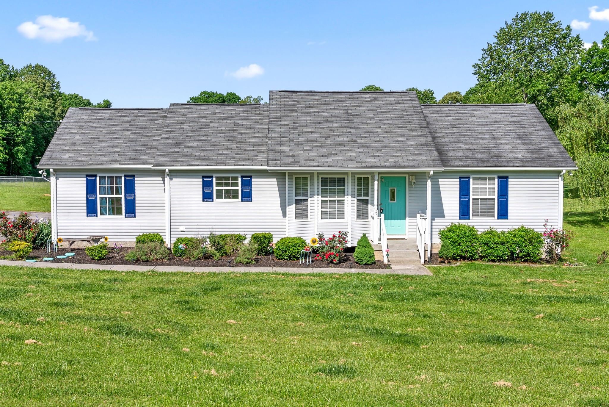 a front view of a house with a garden