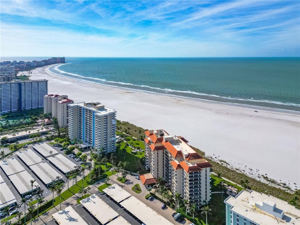 Drone / aerial view featuring a view of the beach and a water view