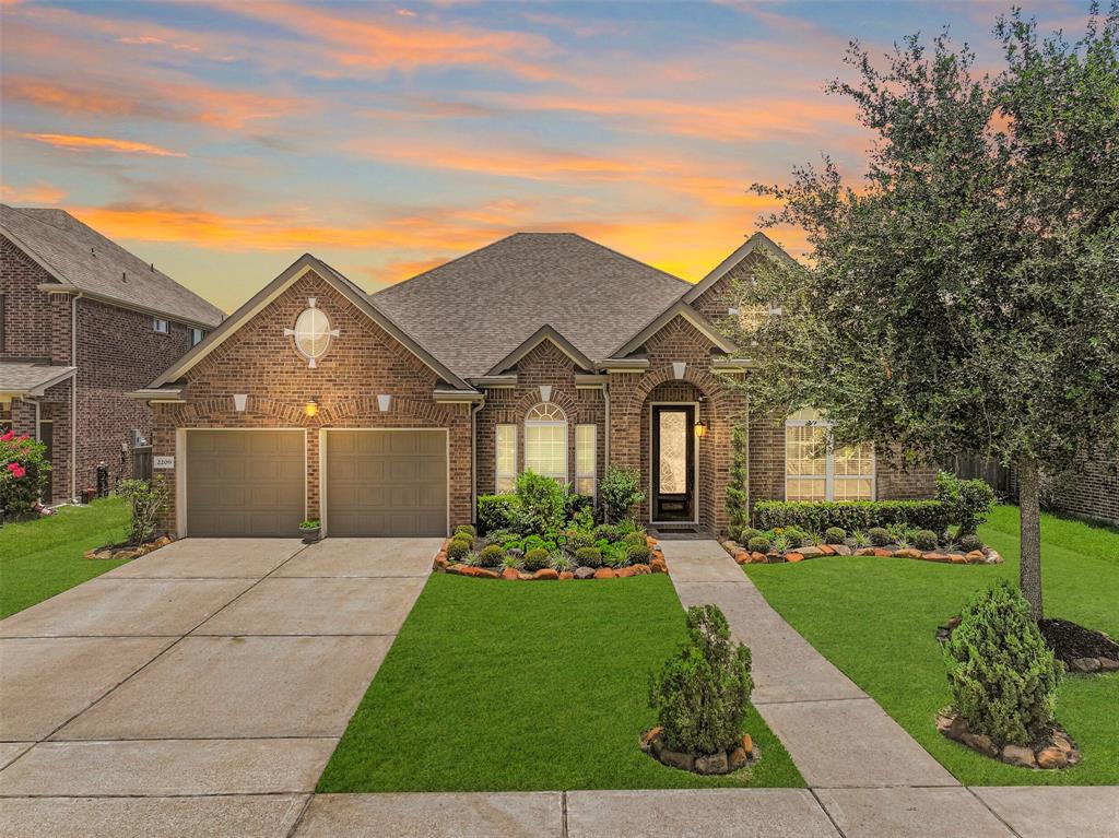 Welcome to 2209 Rocky Shores Lane! This 2016-built single-story home with a brick elevation, keystone accents, a double-wide driveway, and gorgeous landscaping is located in the beautifully kept Riverstone Ranch community in Pearland.