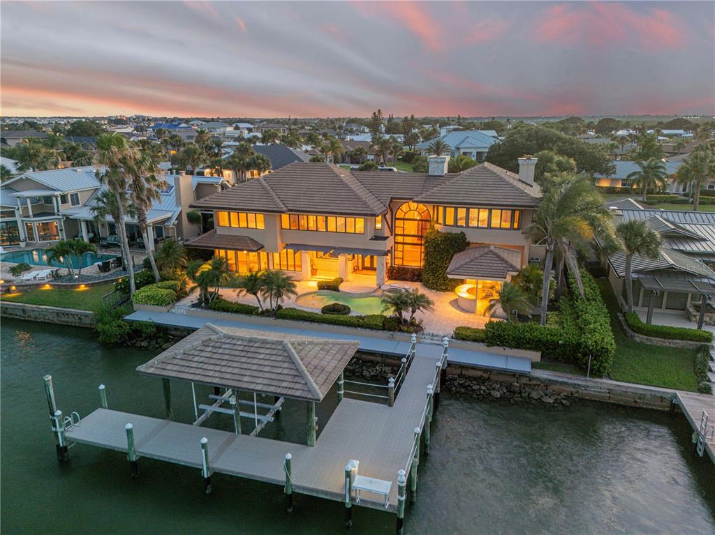 an aerial view of a house with a garden and lake view