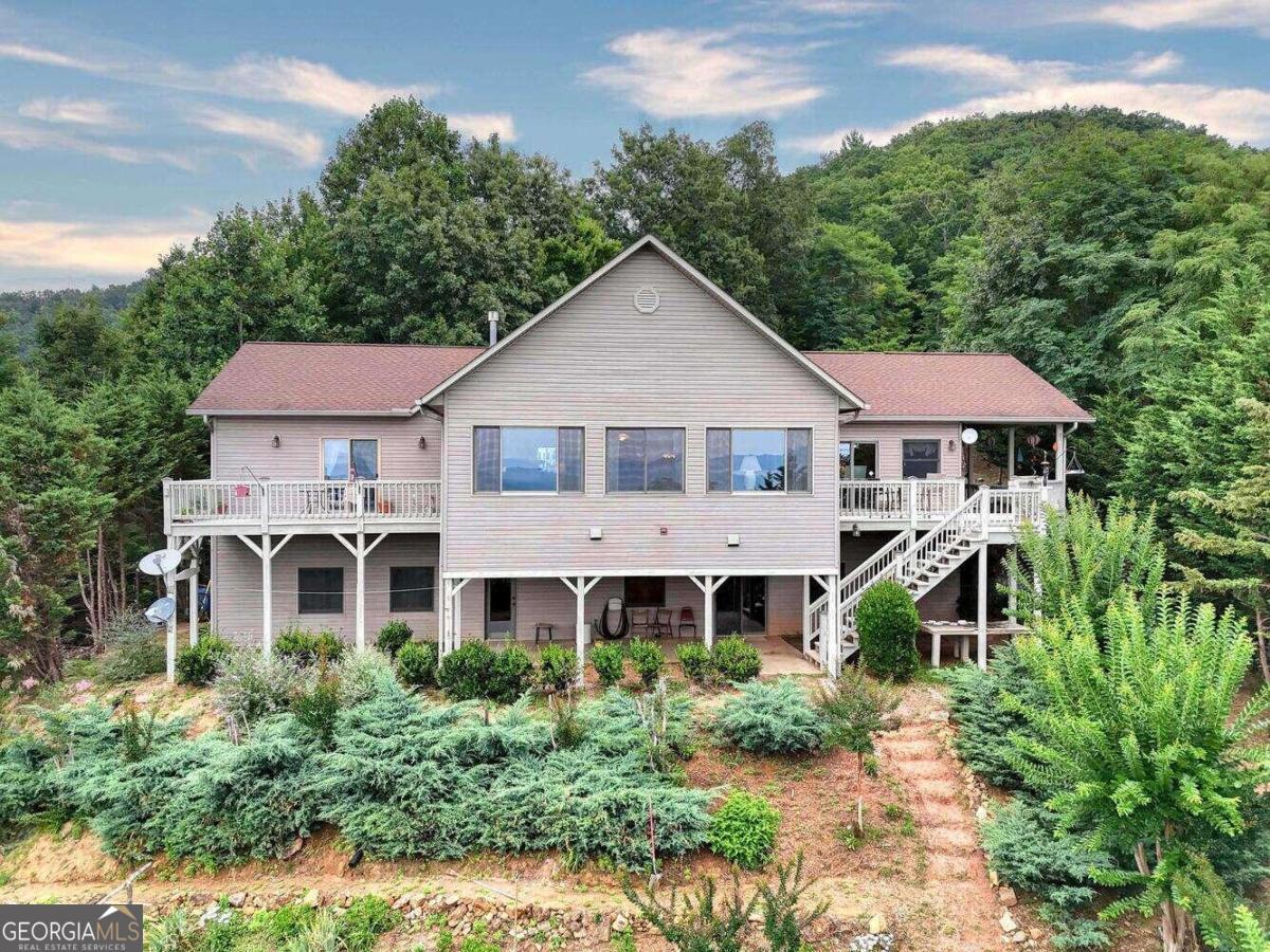 a aerial view of a house with a yard and potted plants