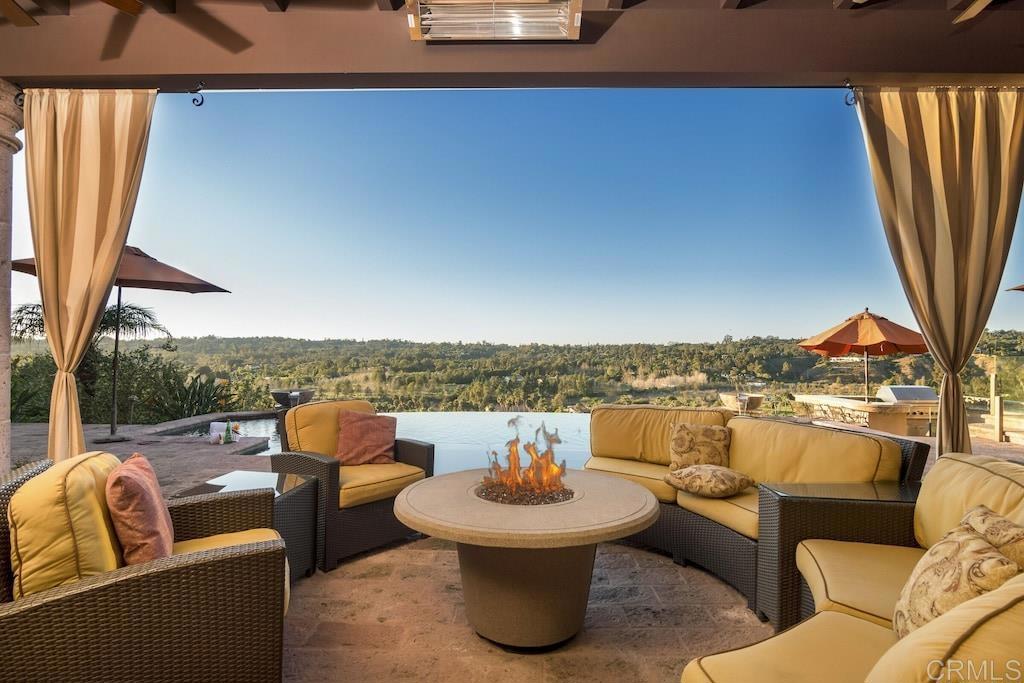 a view of a roof deck with couches and potted plants